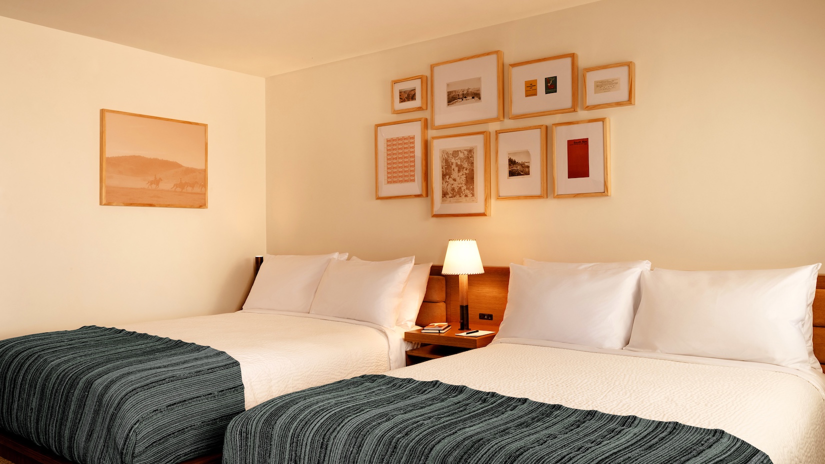 two queen beds and artwork