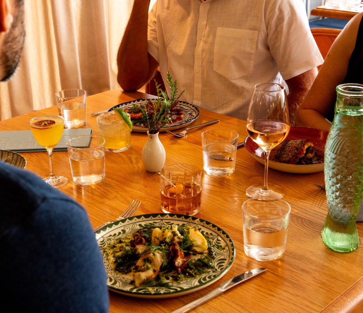 people at a wooden dinner table