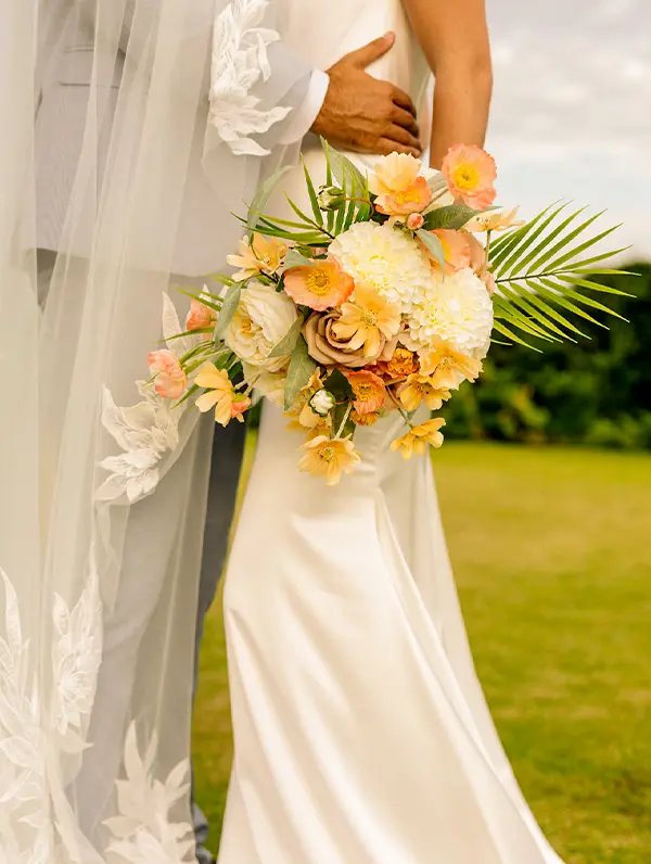 boy and girl carrying bouquet in wedding dress (Shown below shoulder)